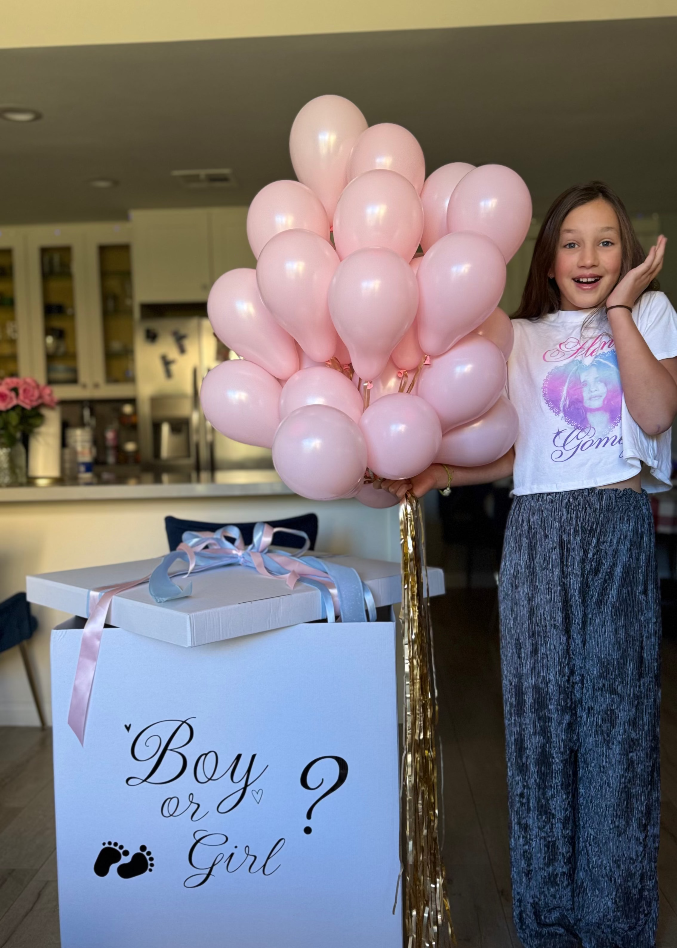 White Boy or Girl gender reveal box with a large bouquet of helium balloons for a baby girl or boy reveal celebrating