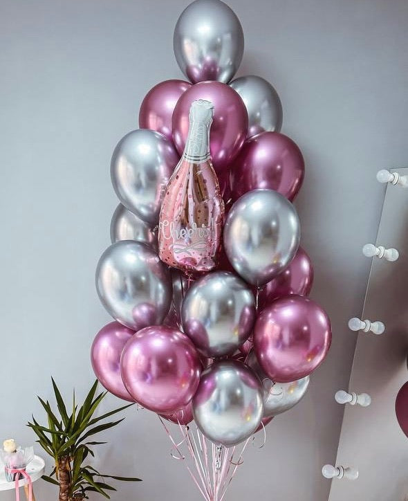 Metallic pink and chrome silver helium balloon bouquet featuring a champagne bottle foil balloon for birthdays and celebration events.