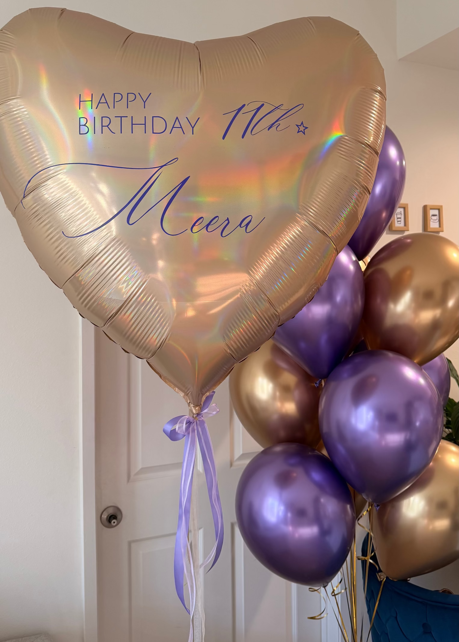 Personalized iridescent heart-shaped birthday balloon with blue lettering, paired with lavender chrome and champagne-gold helium balloons for an elegant 11th birthday celebration.