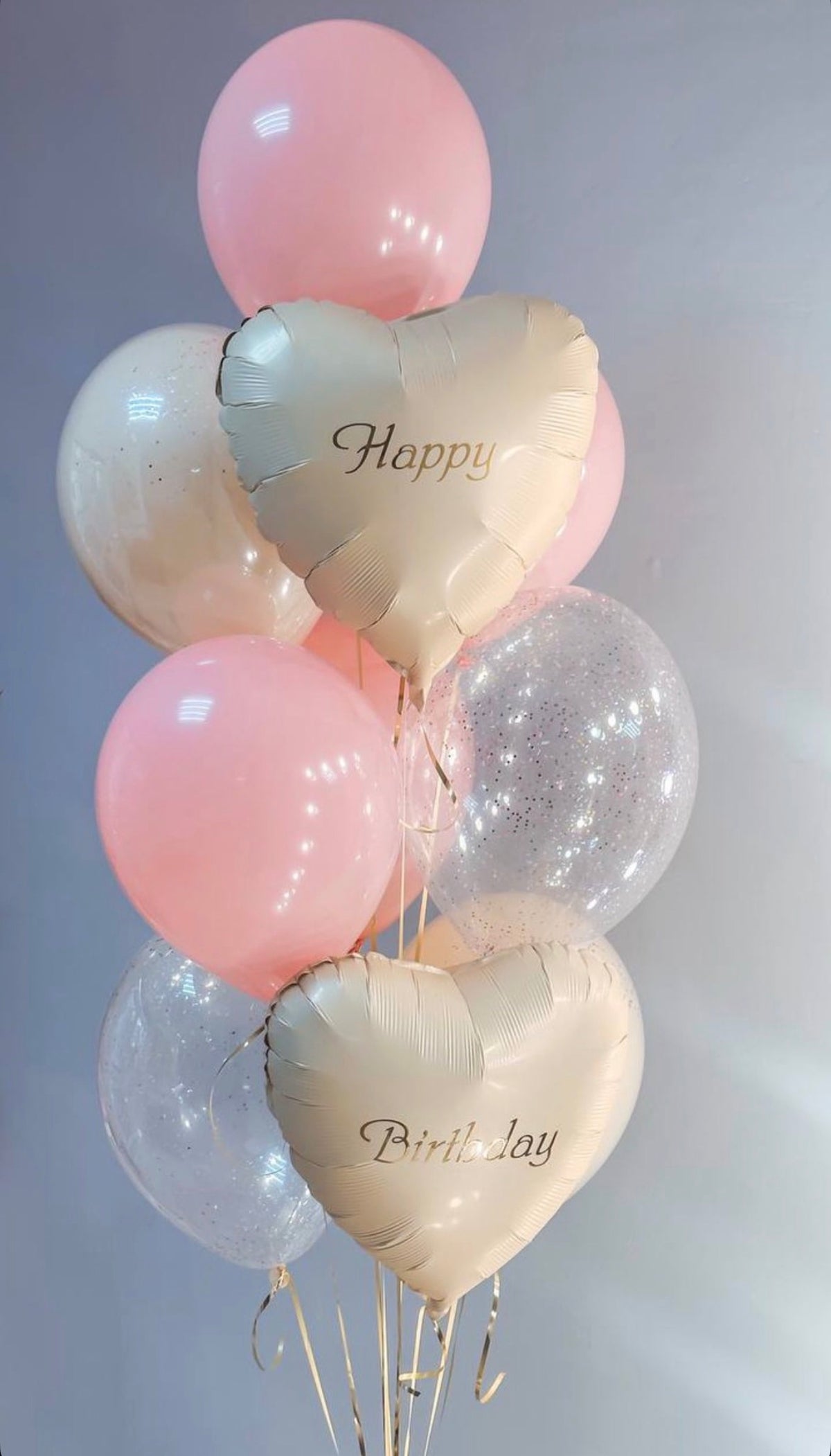 Elegant pastel pink and ivory helium birthday balloon bouquet featuring pearl ivory heart-shaped foil balloons with Happy Birthday lettering, soft pink latex balloons, and clear balloons with sparkling silver confetti. Luxury birthday balloon delivery by Best Balloons LA in Beverly Hills, Bel Air, Brentwood, and Los Angeles.